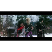 Heavy metal band performing in the snowy mountains from "Vineger Syndrome - Blood Tracks" Blu-ray.