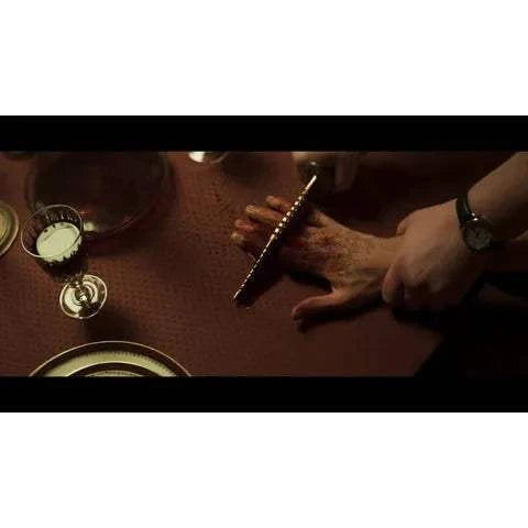 Shudder - The Sacrifice Game Blu-Ray slipcover featuring intense scene with hands and knife.